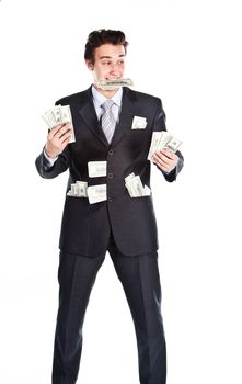Portrait of a young businessman in a dark suit surrounded by flying dollar bills