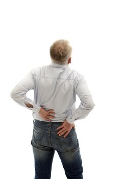 Middle-aged man has back pain. He keeps his back and can be seen from behind.