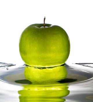 Green apple water splash with white background, high speed splash