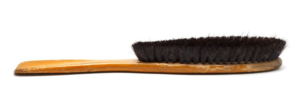 clothes brush with wooden handle issolated on white