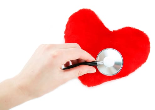 Hand with stethoscope checking a red heart isolated on a white background