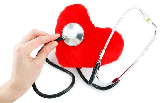 Hand with stethoscope checking a red heart isolated on a white background