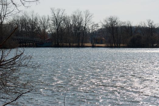 A wooden pedestrian bridge crosses the Huron River.