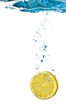 lemon is dropped into water splash isolated on white