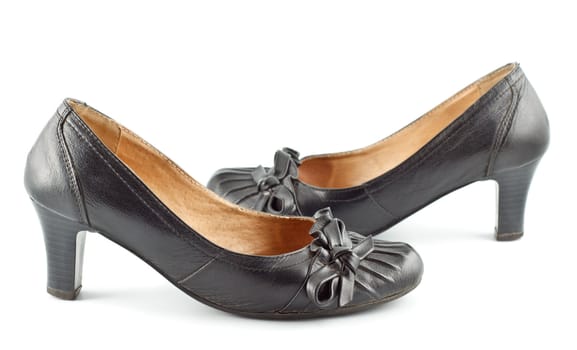 black leather female shoes on grey background