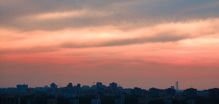 crimson sunset over big city, horizontal orientation