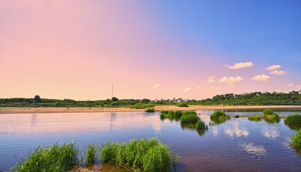 calm river under blue sky at summer day