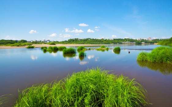 calm river under blue sky at summer day