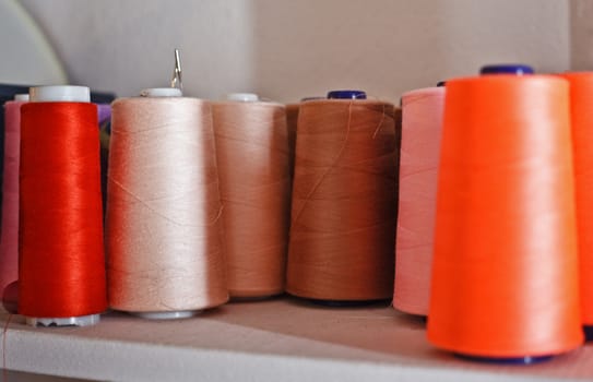 colorful reels of threads on a shelf