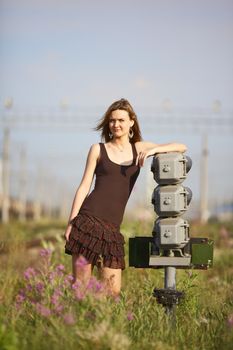 beautiful girl standing on rails near railroad car