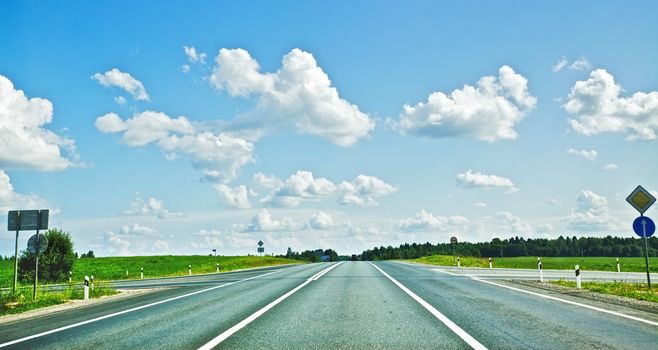 asphalt road under blue sky at summer day