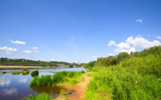 calm river under blue sky at summer day