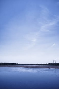 calm river under blue sky at summer day