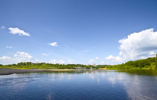 calm river under blue sky at summer day