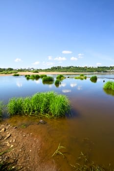 calm river under blue sky at summer day