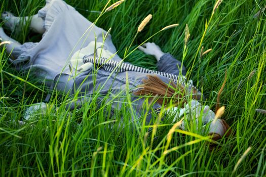 dead woman laying in high grass at summer day