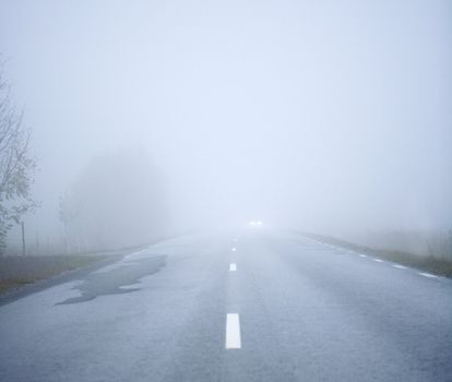 Car driving the Fog Road