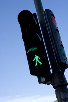 Green Traffic Light towards blue sky