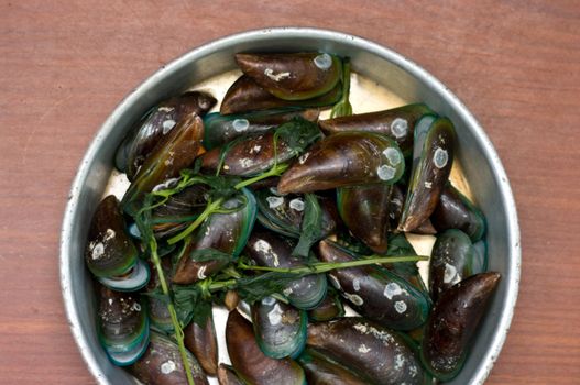 Boiled Asian green mussel on wooden table