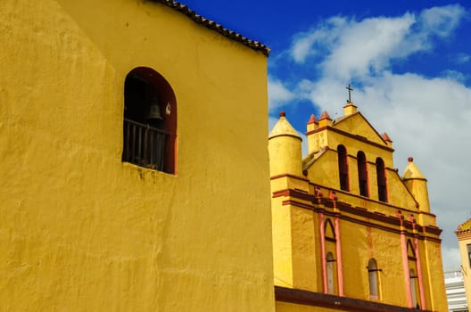 Old yellow colonial church in San Cristobal de las Casas with beautiful blue sky in Chiapas, Mexico