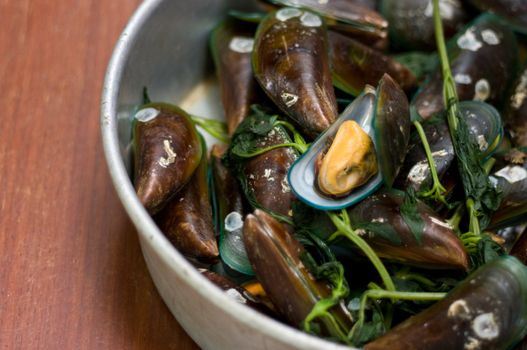 Boiled Asian green mussel on wooden table