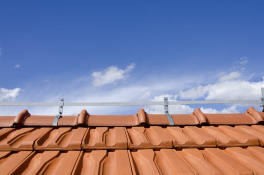 brick roof and blue sky with couple of white clouds