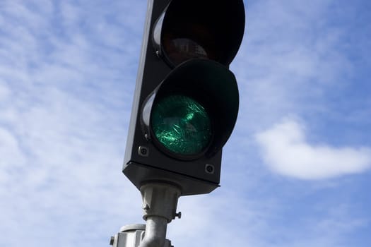 Green Traffic Light towards blue sky