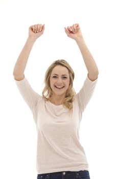 young, pretty woman throws up her arms and cheered in front of white background