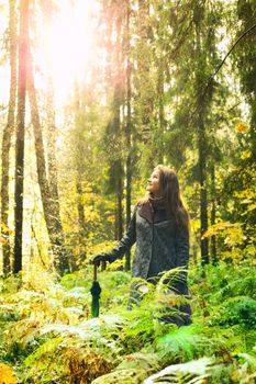 beautiful girl with long hair in autumn rainy forest