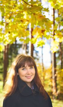 beautiful girl with long hair in autumn rainy forest