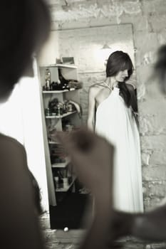 beautiful bride in front of mirror, black and white