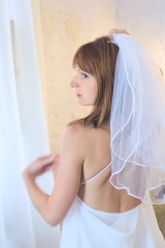 beautiful woman in white wedding dress and bridal veil