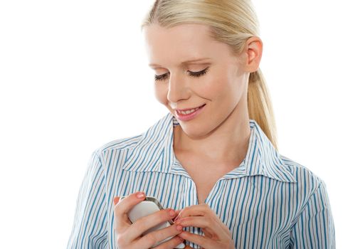 Portrait of a glamourous bussinesswoman texting on white background