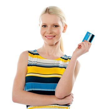 Smiling young girl holding debit-card isolated over white background