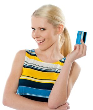 Blond salesgirl posing with credit card and smiling at camera