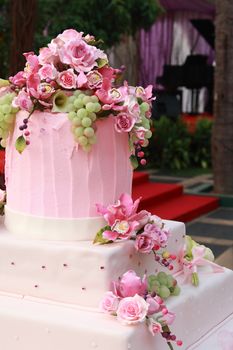 fancy layered wedding cake decorated with flowers
