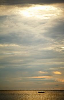 boat on waves under sunset, Andaman Sea, Thailand