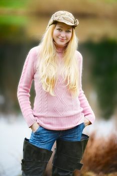 beautiful girl with long blond hair and pink jersey fishing