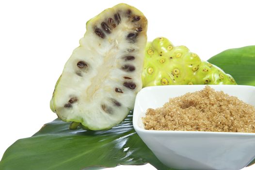 two noni fruit on white background