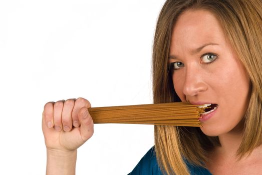 Biting into whole wheat pasta, a healthy nutrition concept