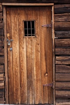 old wild west jail door with small window