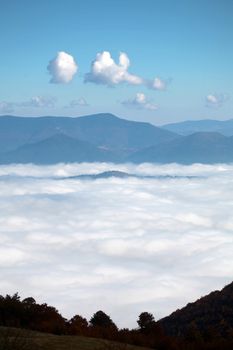 An image a clouds in a mountain