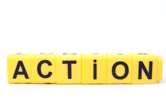 An image of yellow blocks with word ''action'' on them