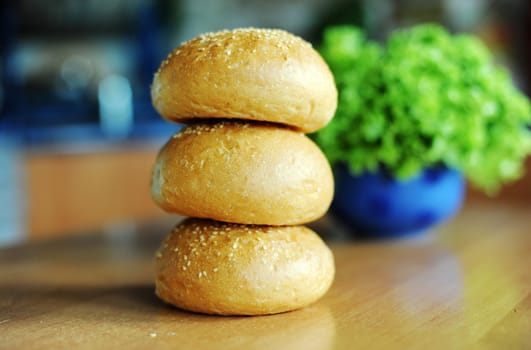 An image of three buns on a kitchen table