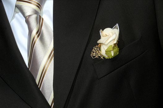 An image of black suit with flower