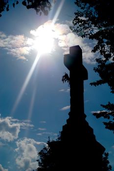 An image of a silhouette of a cross and sun