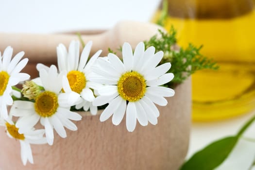 An image of white flowers in wooden mortar