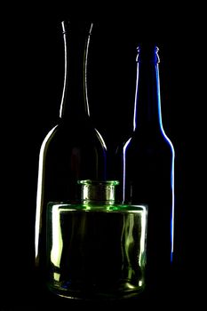 An image of silhouettes of bottles on black background