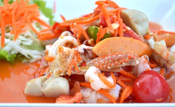 close-up spicy seafood salad on wooden table