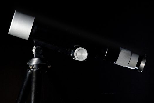 An image of a telescope on black background